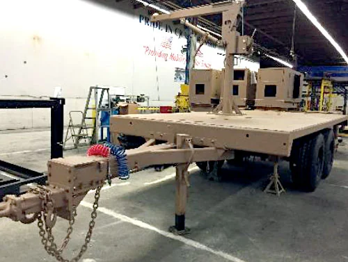 A Silver Eagle flatbed trailer with an integrated crane system